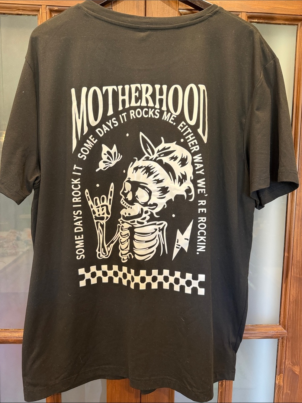 Motherhood Black Tee with White Skeleton Hand Graphic